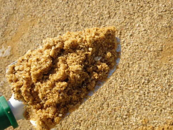 sand on green shovel