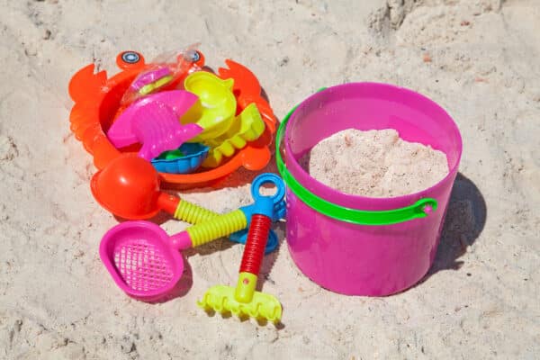 Bright plastic toys on a sandy beach